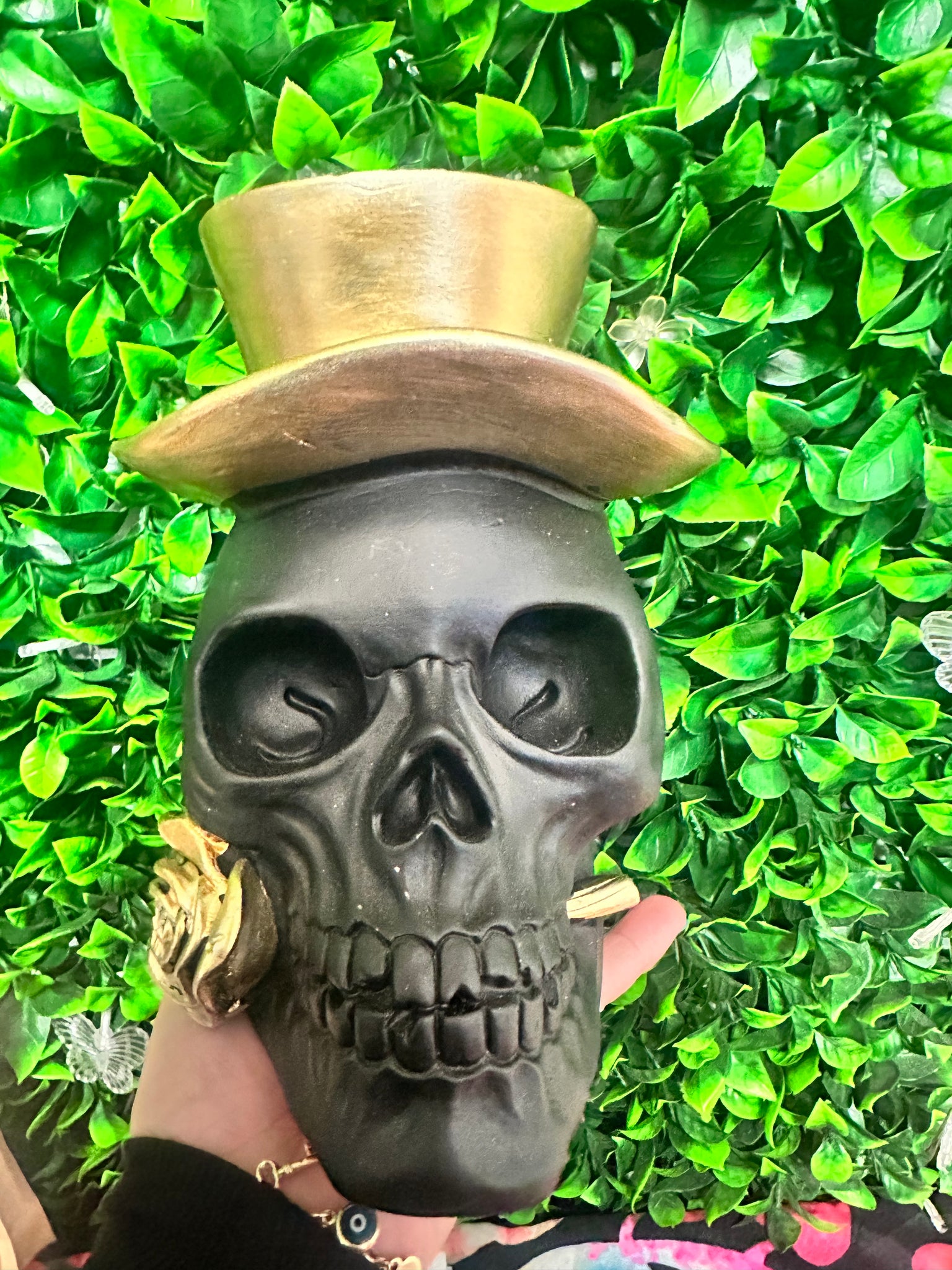 Black skull with gold top hat and rose